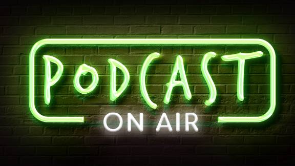 Neon sign that reads 'Podcast on air'.