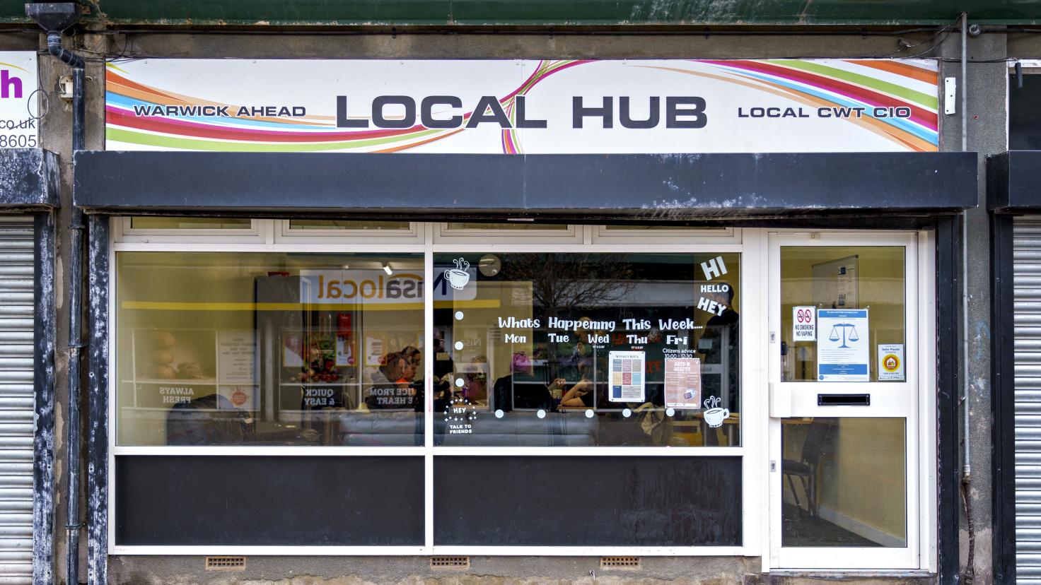 Shop front with a sign over the top reading 'Local Hub'.