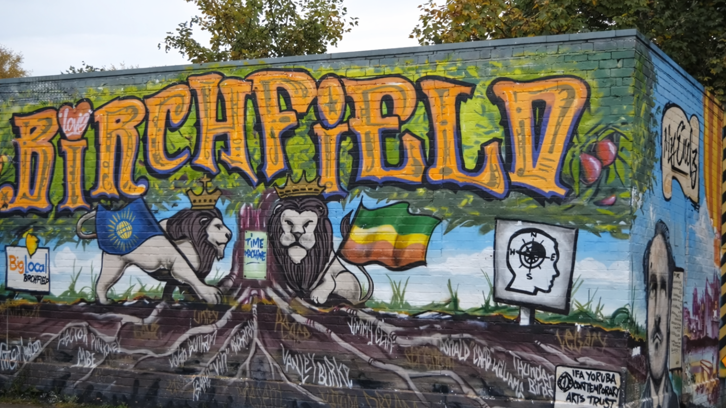 Large painted mural reading 'Birchfield' with two lions wearing crowns