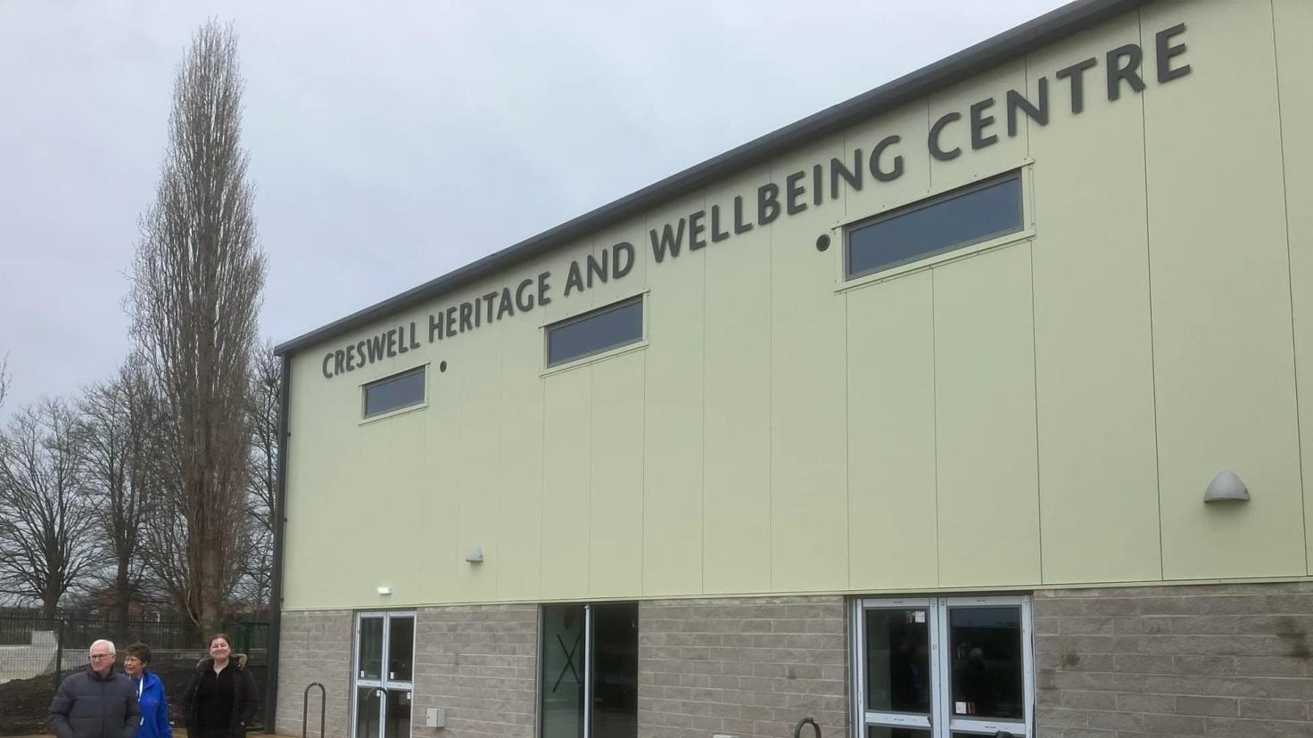 Large white building with the sign Creswell Heritage and Wellbeing Centre.