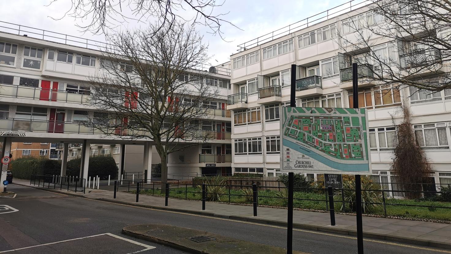 Street sign reading 'Churchill Gardens SW1' with a housing complex in the background