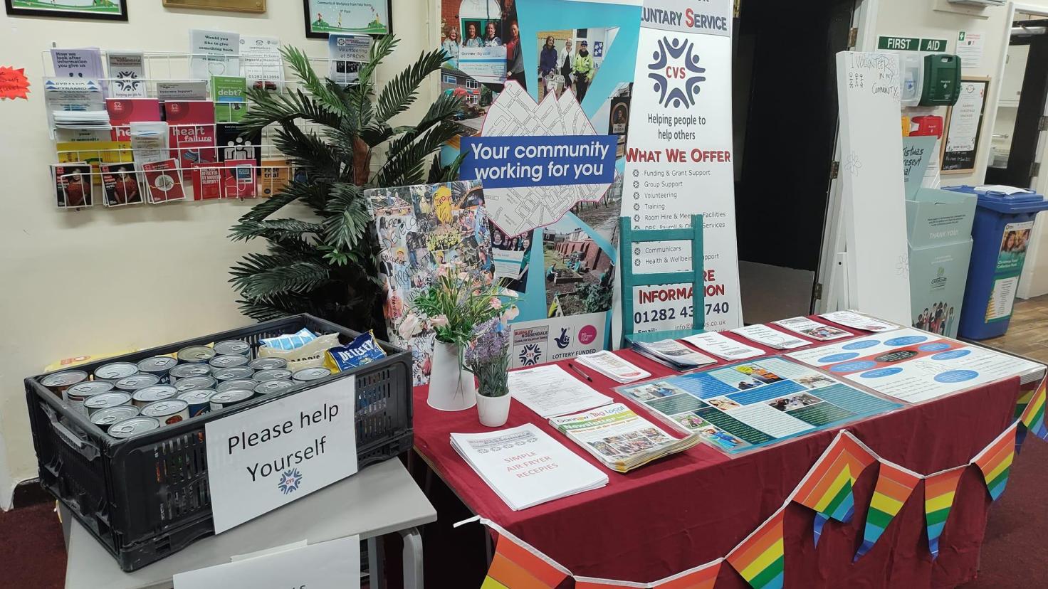 A bright Gannow Big Local stall with rainbow flag bunting