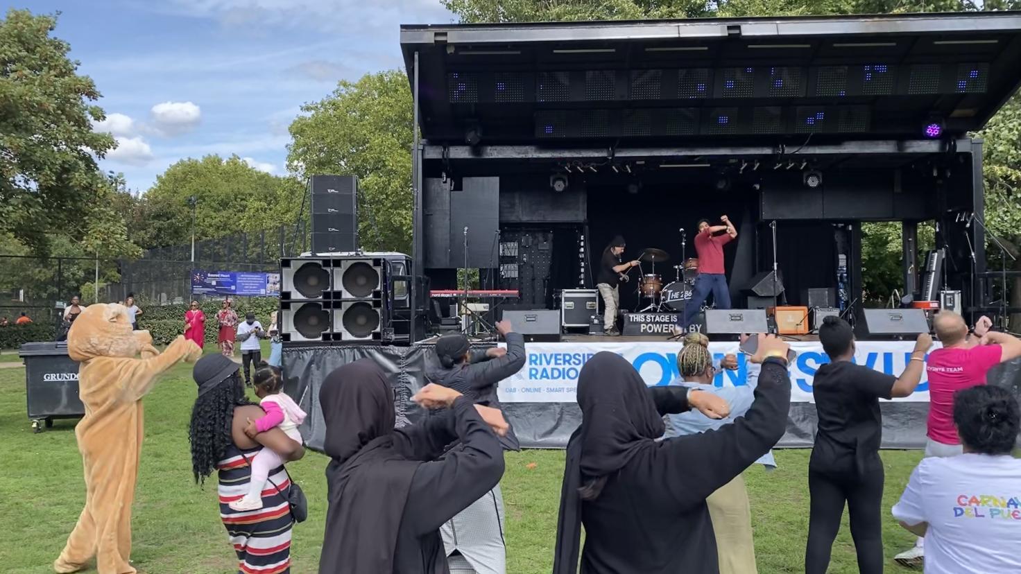 People dancing in front of a stage
