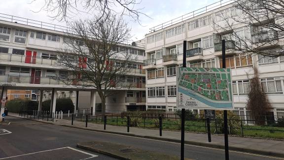 Street sign reading 'Churchill Gardens SW1' with a housing complex in the background