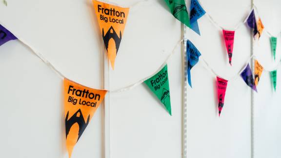 Neon bunting reading 'Fratton Big Local'.