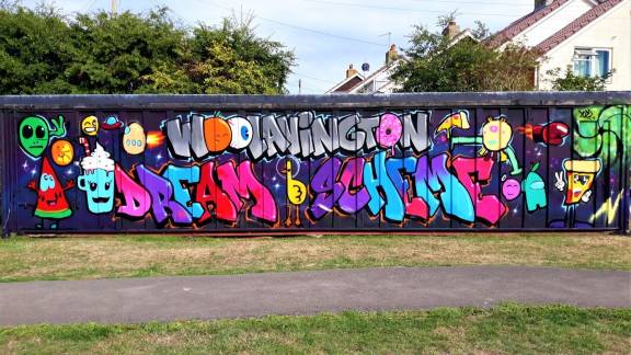 A colourful graffiti-style mural on a concrete wall.