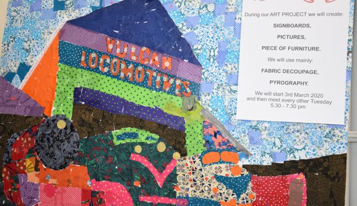 A colourful mixed media collage of a building with the words 'Vulcan Locomotives.'