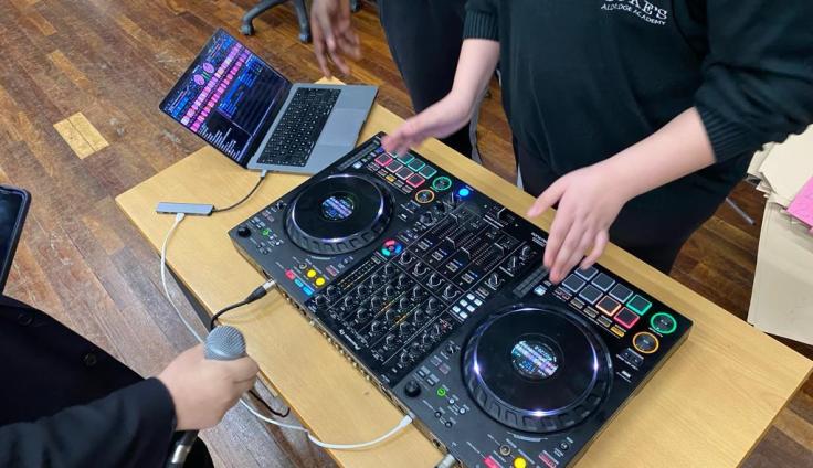 A mixing desk and laptop on top of a table