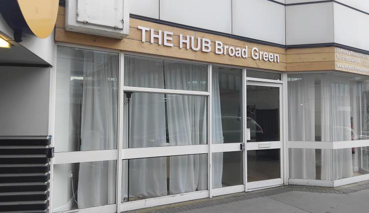 A mid-century office building with a sign reading 'The Hub Broad Green' over the door.