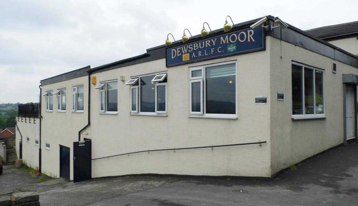 Cream-coloured building on a slope with a sign reading 'Dewsbury Moor A.R.F.L.C.