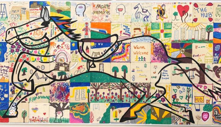 A mosaic of many painted white tiles with a line drawing of a horse across the piece.