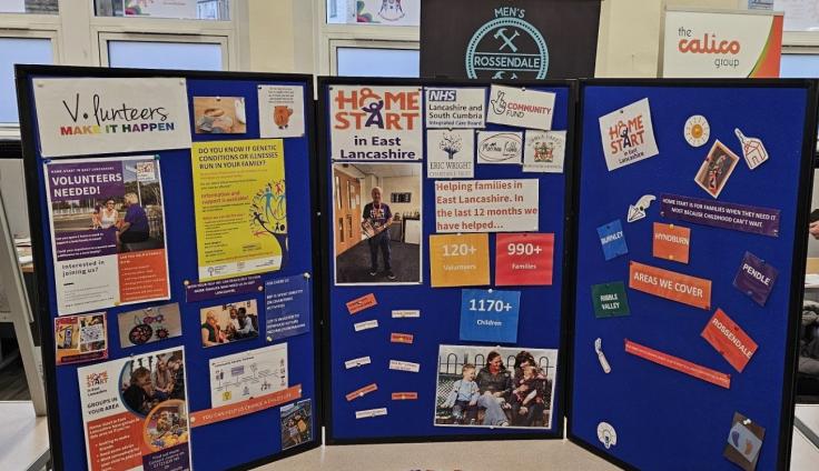 A colourful table display showing local organisations' leaflets and information.