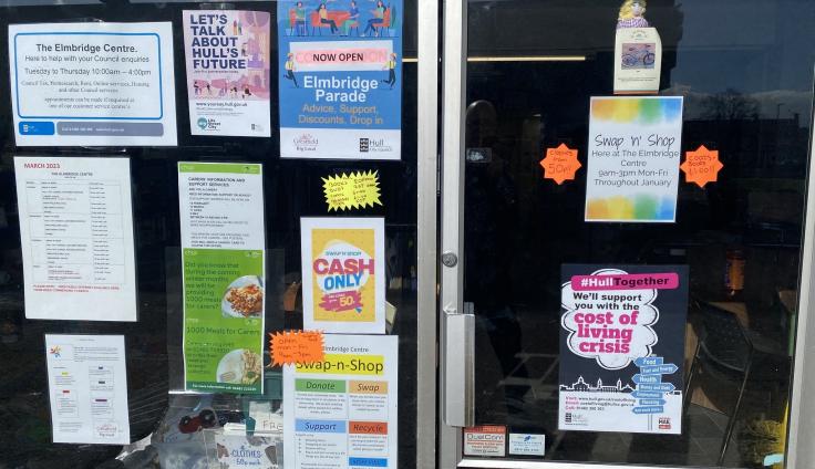 A small glass-fronted commercial unit with colourful posters in the windows.