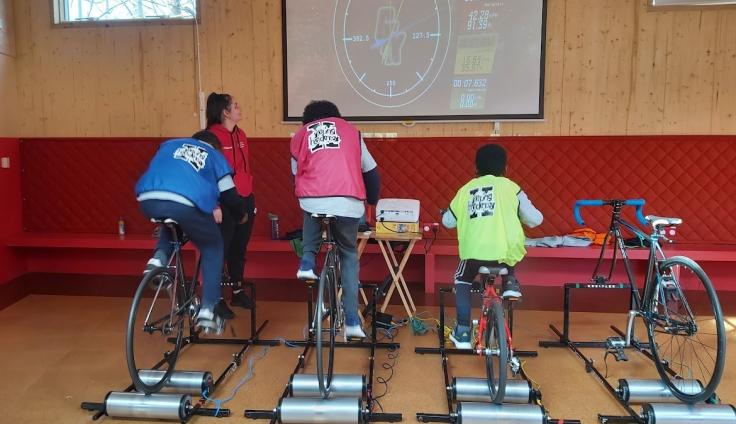 Young people using indoor exercise equipment.