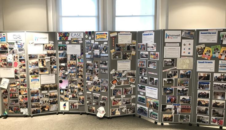 Concertina noticeboards covered with posters and photographs.