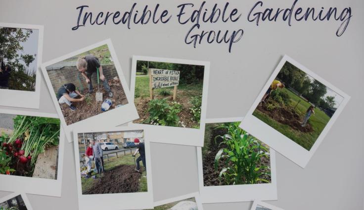 A close-up of a display board titled 'Incredible Edibles Gardening Group' showing photographs of people working on garden areas and edible garden produce.