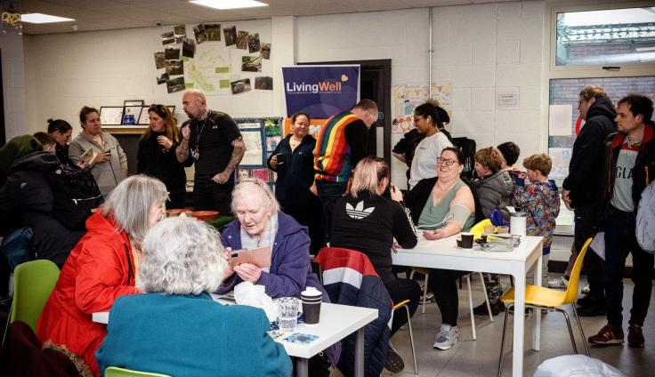Lots of people sitting at tables and talking.