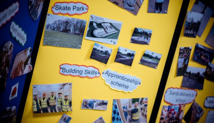 A display board with photographs and text.