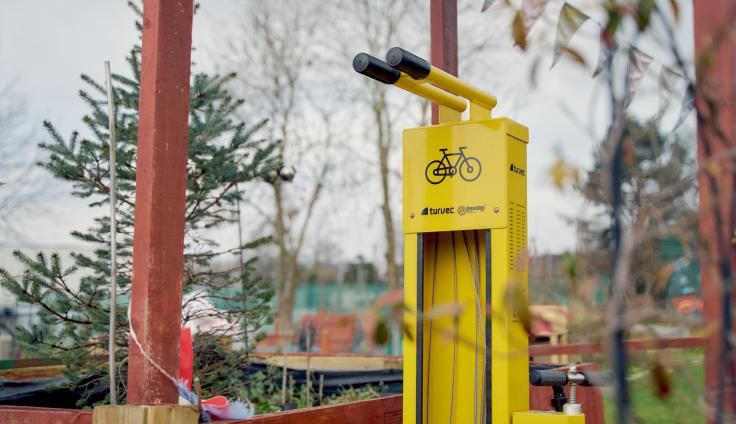 A yellow tyre pump with a symbol of a bike.