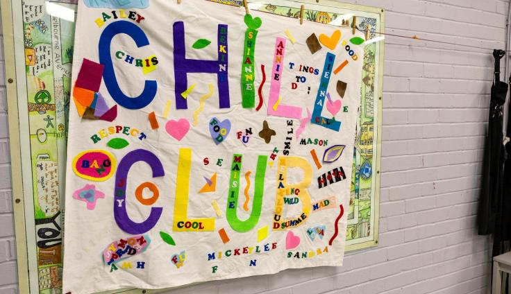 A colourful appliqued banner spelling out 'Chill Club'.