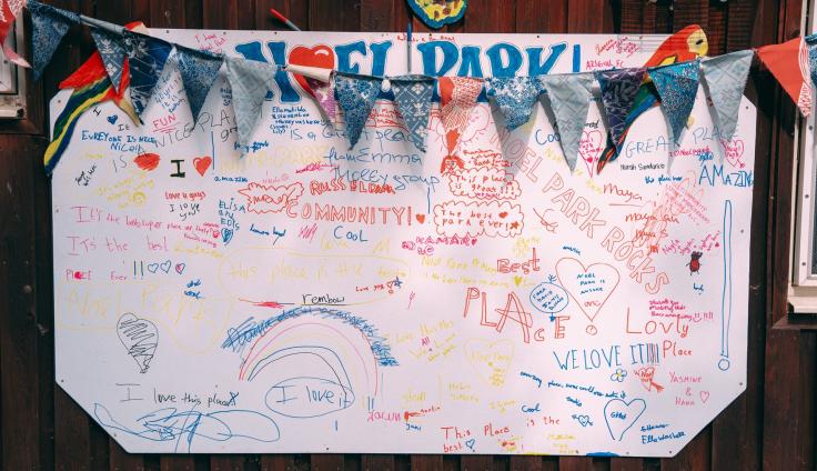Bunting over a large paper banner covered in drawings and comments written in colourful pen.