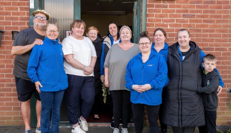 Ten partnership members and volunteers from Northwood Together standing outside their office.