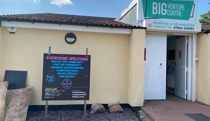 A single-storey building with a sign reading 'Everyone welcome' by the door.