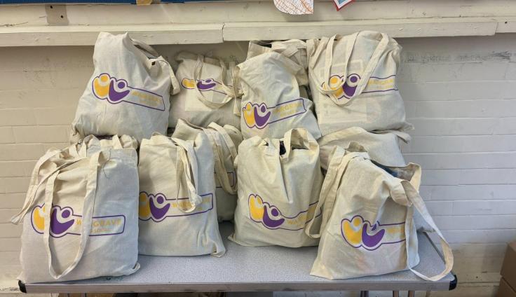 A pile of filled white drawstring bags.