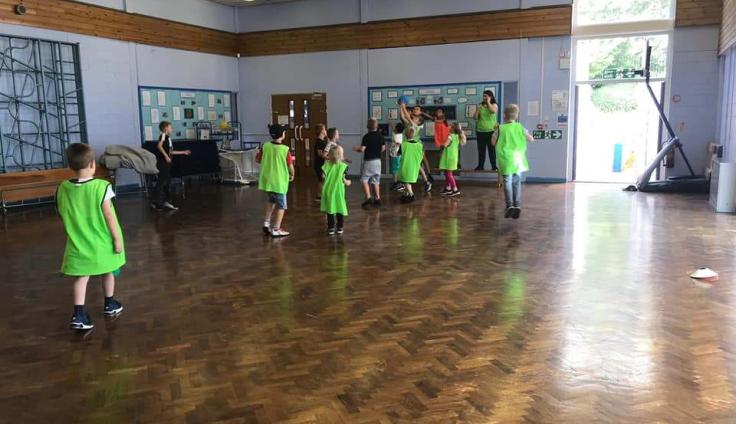 A group of children playing in a community hall.