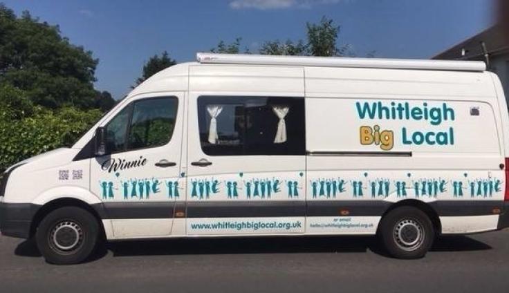 A large white passenger transport van, with curtains, and signwriting reading "Whitleigh Big Local".