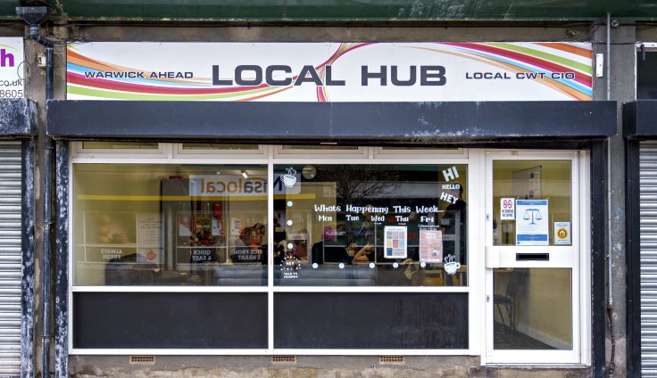 Shop front with a sign over the top reading 'Local Hub'.