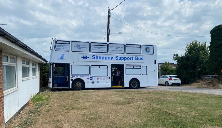 A white double-decker bus with 'Sheppey Support bus' on the side livery.