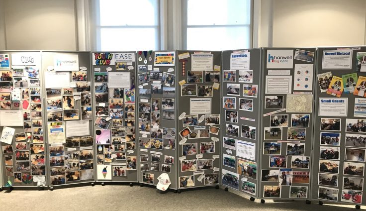 Concertina noticeboards covered with posters and photographs.