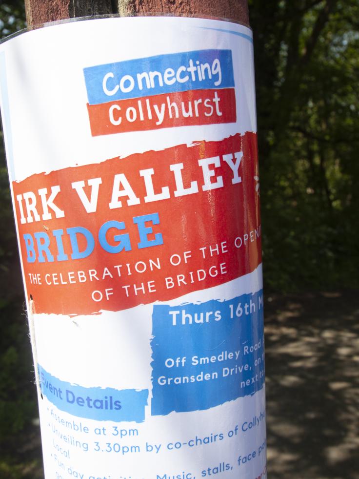 A poster on a wooden pole, advertising the celebration of the opening of the Irk Valley Bridge.